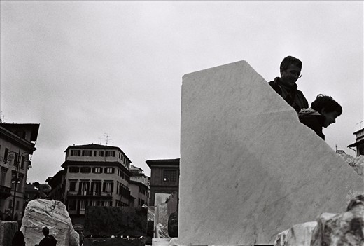 Families play amongst large marble blocks placed in Piazza Santa Croce as part of the Florens 2012 Festival. Florence, Italy.