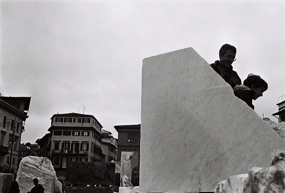 Families play amongst large marble blocks placed in Piazza Santa Croce as part of the Florens 2012 Festival. Florence, Italy.