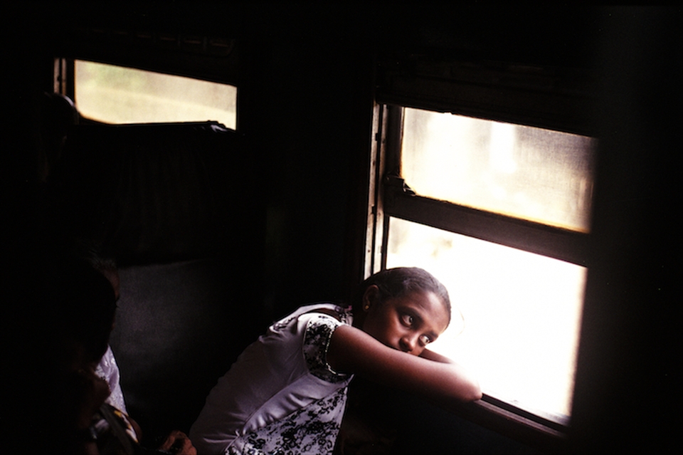 Lucky enough to get a seat, a girl looks out with longing at the beautiful views