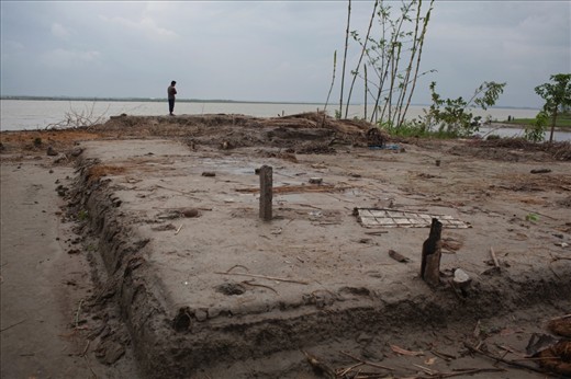 TENGRAKANDI, BANGLADESH - August 2011. The remains of a raised plinth, 10 families havebeen forced to migrate in the last few days afterthe Jamuna River reached their doorstep.