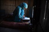 EAST GABGACHHI, BANGLADESH - August 2011. Shazeda Khatun (18) studying the Koran in her home in East Gabgacchi. She has been living on this char for 6 months after her family was forced to migrate when their home was eroded. The char island is extremely low lying and is susceptible to flooding during the monsoon season. : by matthewsstuart, Views[401]