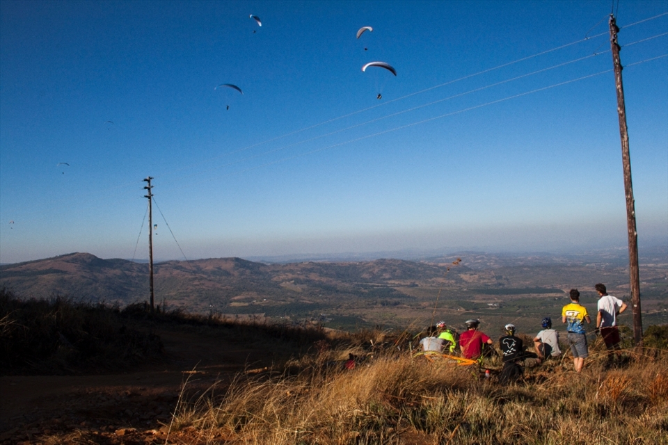  After an early Winter morning start and many hours on the bike we turned a corner to be greeted with an amazing sight, at least 15 paragliders sailing in the wind as if on invisible waves. A breathtaking sight, a sight we found deserving of a perfect place to rest our legs and refuel our energy for an afternoon lunch in the mountains.