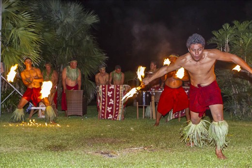 Samoan culture is highly social and here the use of the coconut tree leaves can be seen used for leg and neck decorations for the dancers and musicians performing the traditional fire dance at the end of an evenings meal and entertainment.