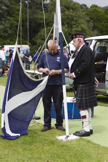 The Scottish Flag is prepared under the watchful eye of the Master of Ceremonies