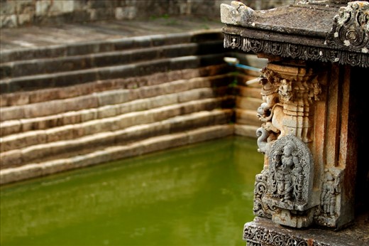 A kund (stepped well) in Channakeshava Temple - Belur.
Since early days, the design of water storage plays an important role in Indian temple architecture.
people used to travel on bullock-cart, horse-cart or feet and there were no hotels or motels  
so temples used to be a place where they took shelter to rest and relax; for their inhabitation there was provision of water inside the temple in the form stepped well or tank (Kund), water in these kunds came either from river or other natural resource. 
Some kunds were also believed to have holy water in them and taking bath in it could cancel their sins and cure sickness. 
