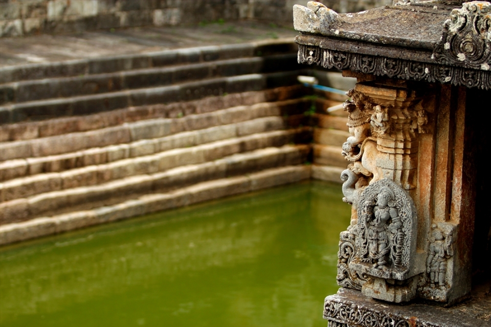 A kund (stepped well) in Channakeshava Temple - Belur.
Since early days, the design of water storage plays an important role in Indian temple architecture.
people used to travel on bullock-cart, horse-cart or feet and there were no hotels or motels  
so temples used to be a place where they took shelter to rest and relax; for their inhabitation there was provision of water inside the temple in the form stepped well or tank (Kund), water in these kunds came either from river or other natural resource. 
Some kunds were also believed to have holy water in them and taking bath in it could cancel their sins and cure sickness. 
