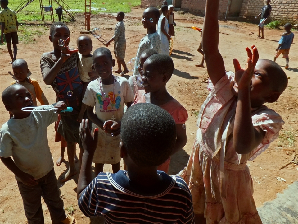 Gifts: The children enjoy some exciting gifts from their visitors.