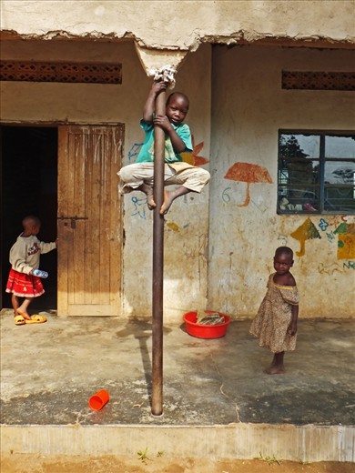 Cheeky Monkey: A young boy shows of his climbing skills on the buildings supports