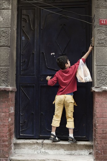He happily runs from the bakery with the morning bread.