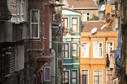 A grocer waits below to fill the descendng bucket with morning goods.