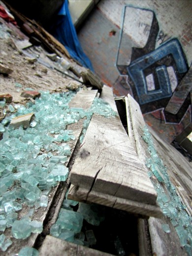 Detroit's now abandoned Packard Plant once manufactured automobiles. The damaged boards and glass of a shattered past does not have to remain that way. Detroit's rejuvenation awaits.