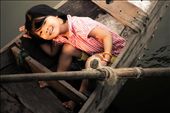 Pure Innocence - While watching the traffic jam in the water of boats coming into sell food at the market I glanced down to see her beautiful smiling face. She played a bit of hide and seek with me....by the time I ran to the other side of the bridge I was able to capture her 