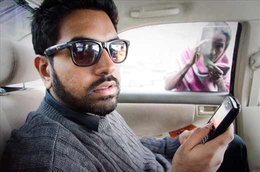 Gulshan resisident ignores the reality of the street from his private car. 