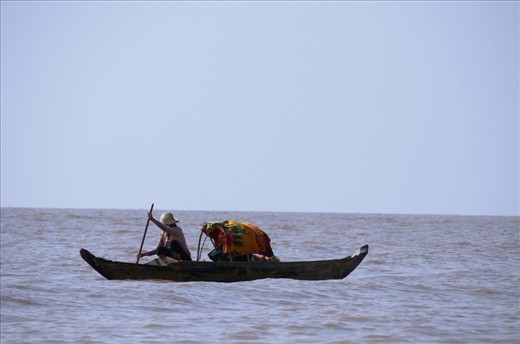 Tonle Sap Lake. January. 2013. Mother and baby under makeshift canopy.It was the first boat I saw on the horizon as we neared the fishing village.