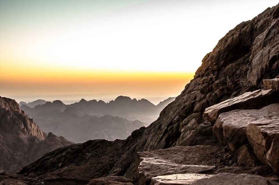 Morning Sinai: just at dawn, from the spot i picked to camp the night near top of St. Catherine mountain, showing the misty wet rock stairs made by humans to reach the top of the mountain, and the graded effect of mountain tops and horizon of clear sky in south sinai. it looked like high building roofs! 

Dahab is a quite small city in south Sinai, it is a touristic attraction for all nature lovers, and these 5 photos are not pure nature photos! they all have some human touch, telling the story of the enormous peacefully beautiful nature enclosing and containing the limited and balanced human manipulation; opposite to what we see in urban areas and huge modern cities - where we cannot watch stars, or sunset, or even enjoy a quite time!
