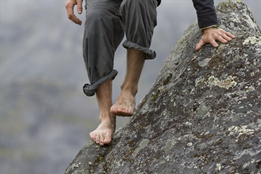 After Bouldering for a while in Hatcher Pass, Ak Seth Richardson's feet start to bleed on the wet slab of rock covered in spots of lichen. 