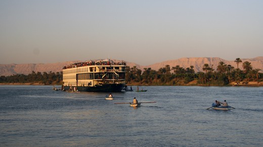 When the large cruise ships are waiting at the Aswan Dam, small boats are drawing closer trying to sell some merchandise to the passengers.