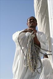 The galabia is the traditional garment for Egyptians.  Made from thin white Egyptian cotton, it is the perfect attire for working a long day on the boats in the sun.: by mermaid, Views[860]