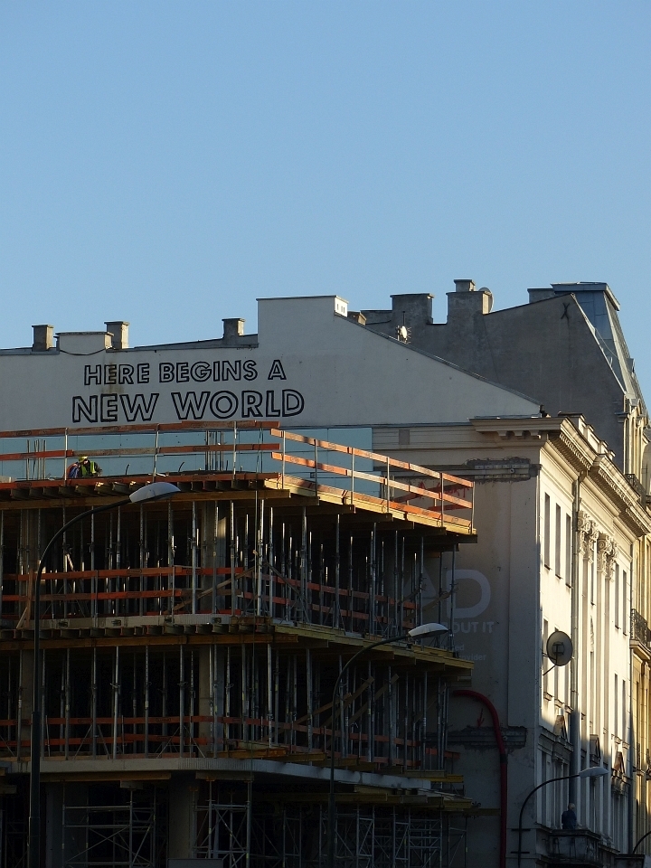 Words written on a beautiful building soon to be hidden by glass and concrete.