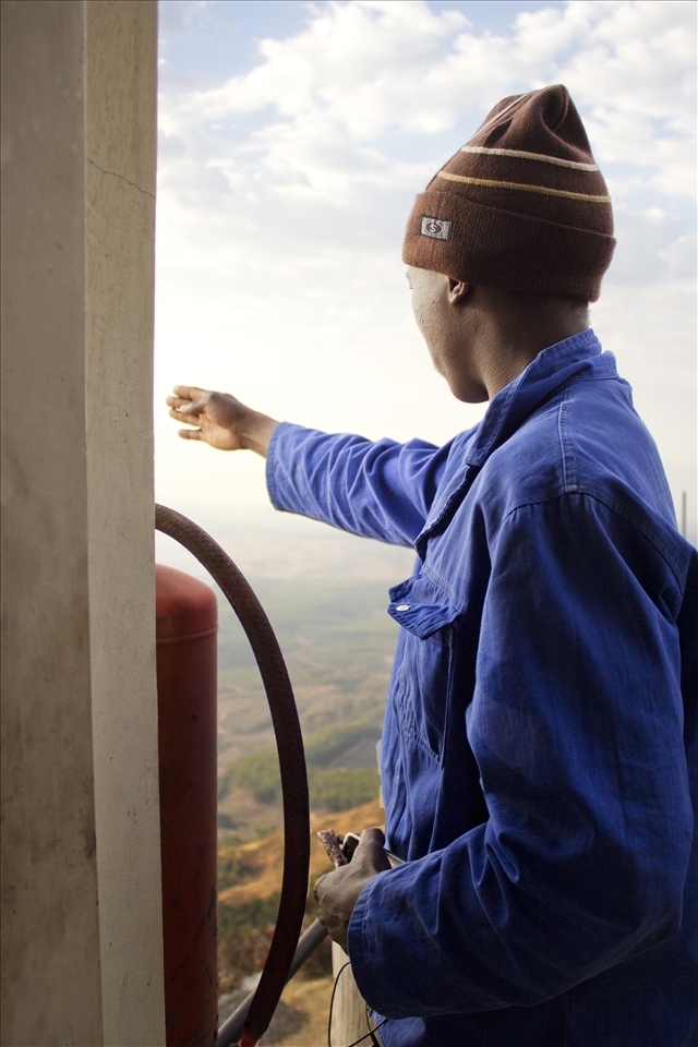 While explaining where the area’s other three lookout posts are situated, Nelson Matsewjwa points into the direction of Nelspruit, Mpumalanga’s capital city, South Africa. Standing at the top of the tower, Matsewjwa clutches onto his phone and a piece of 
