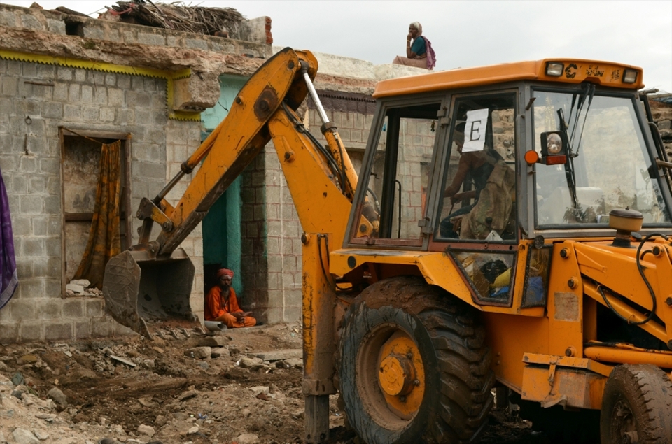 Ordered by the ASI (Archaeological Survey of India) a bulldozer removes the remnants of homes built upon a UNESCO World Heritage site to 'protect' the monuments of Hampi, India.