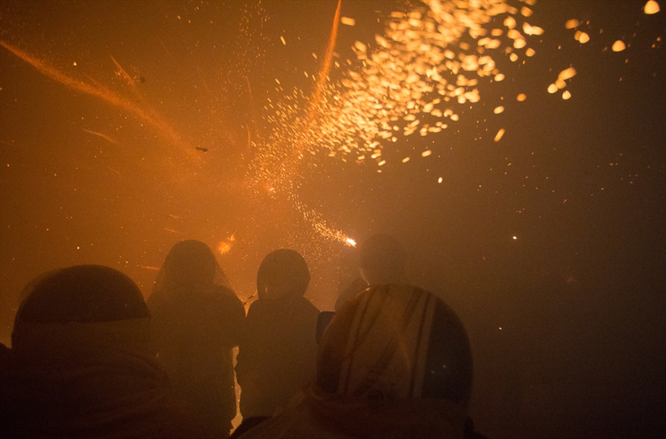 Smoke fills the area as bottle rockets continue blazing past everyones' heads.