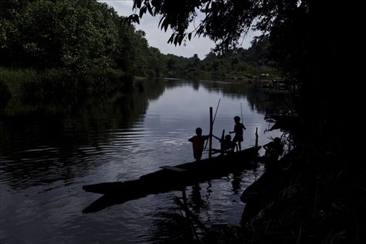 Papua children playing and fishing in the river bank of Kais River
