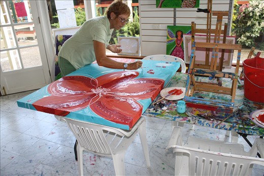 Woman painting flowers in an art shop