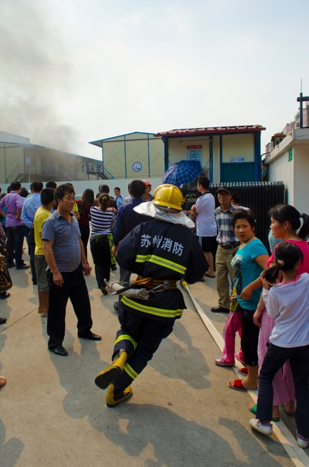 A fireman runs to the building to assist those already fighting the blaze.