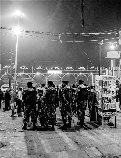 In the background of this picture, there is a little community centre situated atop a sari shop. There is a pink cement widing staircase that leads up to a verandah where two women had been pounding little pieces of dough into chapati. Every night after the puja, the community centre gives out food to the poor and homeless. We were there to help distribute the food. While waiting for everyone, I turned back and saw this group of policemen. There were non-functional metal detectors located all along the entrances to the ghats. There were policemen watching the puja from higher up with their big big guns. I snapped a picture when I finally saw one of them smile.