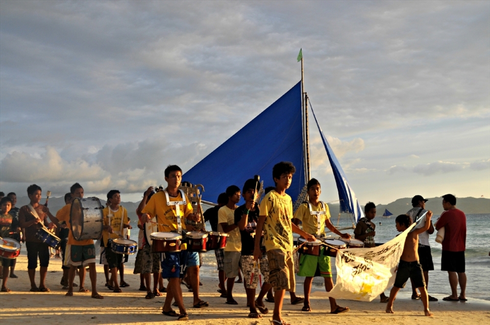 This was taken during the fiesta in Boracay. I had just come back from spending the day aboard a yacht with my office mates. When I was walking back home, I saw these boys with the drummers right behind them.