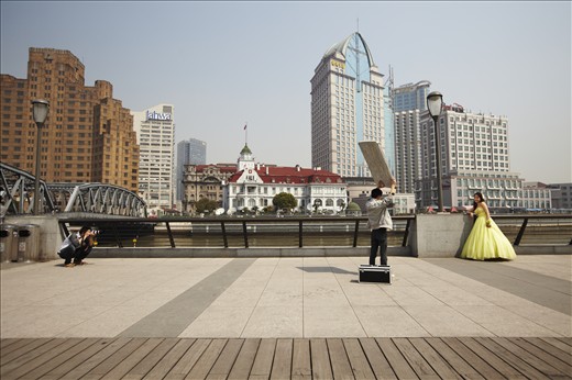 Evolving fashion: A bridal fashion shoot takes place on The Bund, Shanghai. Traditionally, Chinese brides wore red, a colour associated with luck and prosperity. The colour white, symbolising death and mourning, was considered taboo. Nowadays, white, western-style dresses are popular as a symbol of middle class status and progressive ideals.
