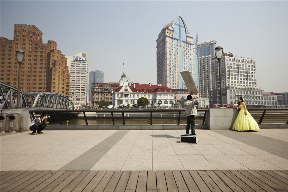 Evolving fashion: A bridal fashion shoot takes place on The Bund, Shanghai. Traditionally, Chinese brides wore red, a colour associated with luck and prosperity. The colour white, symbolising death and mourning, was considered taboo. Nowadays, white, western-style dresses are popular as a symbol of middle class status and progressive ideals.
