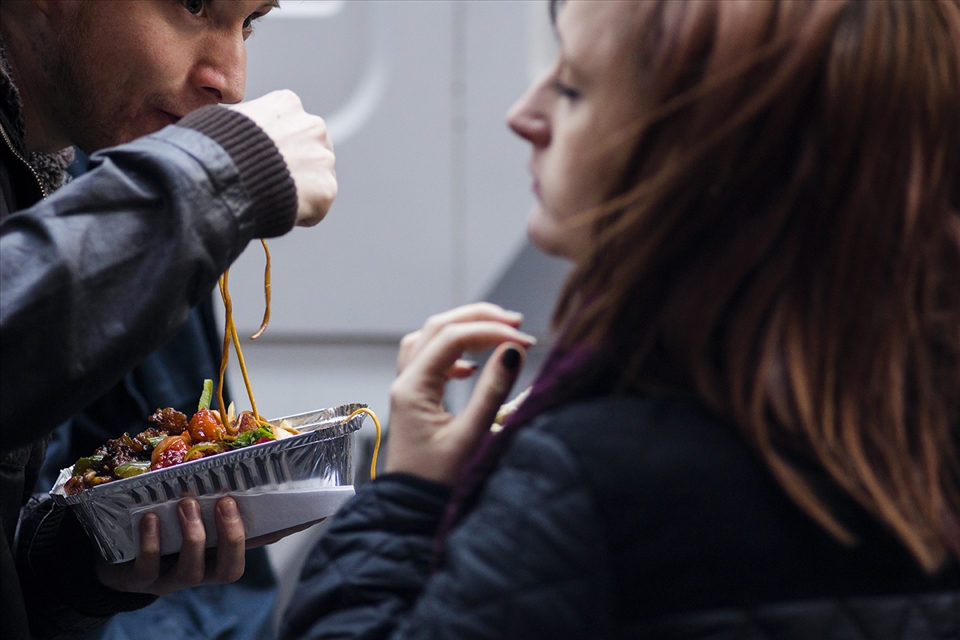 A couple shares a mix of vegetables with noodles,. Its a new experience!