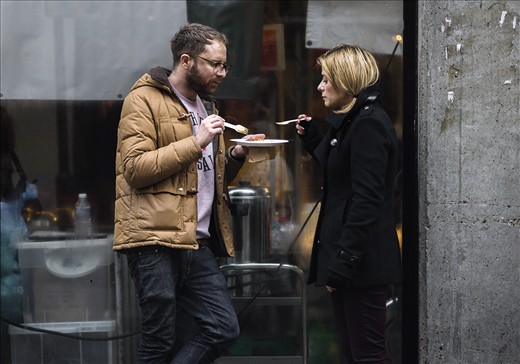 Londoners share their meal in the street. Outside the Food hall market.