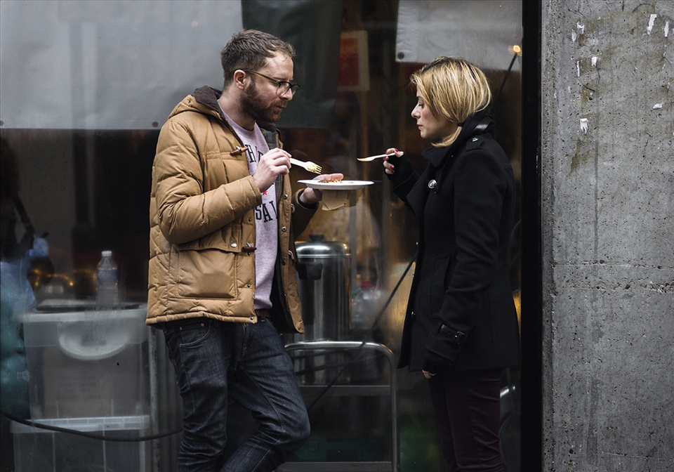 Londoners share their meal in the street. Outside the Food hall market.