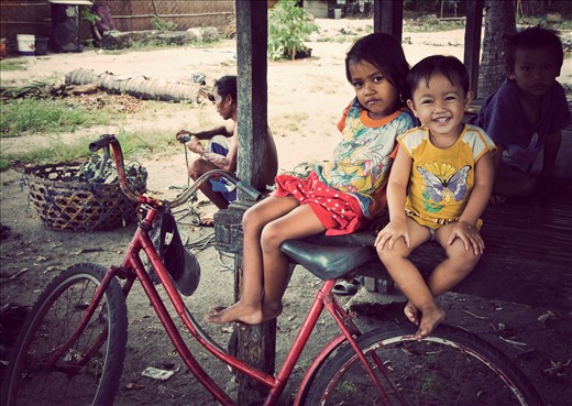 Happy kids snapped while travelling by scooter