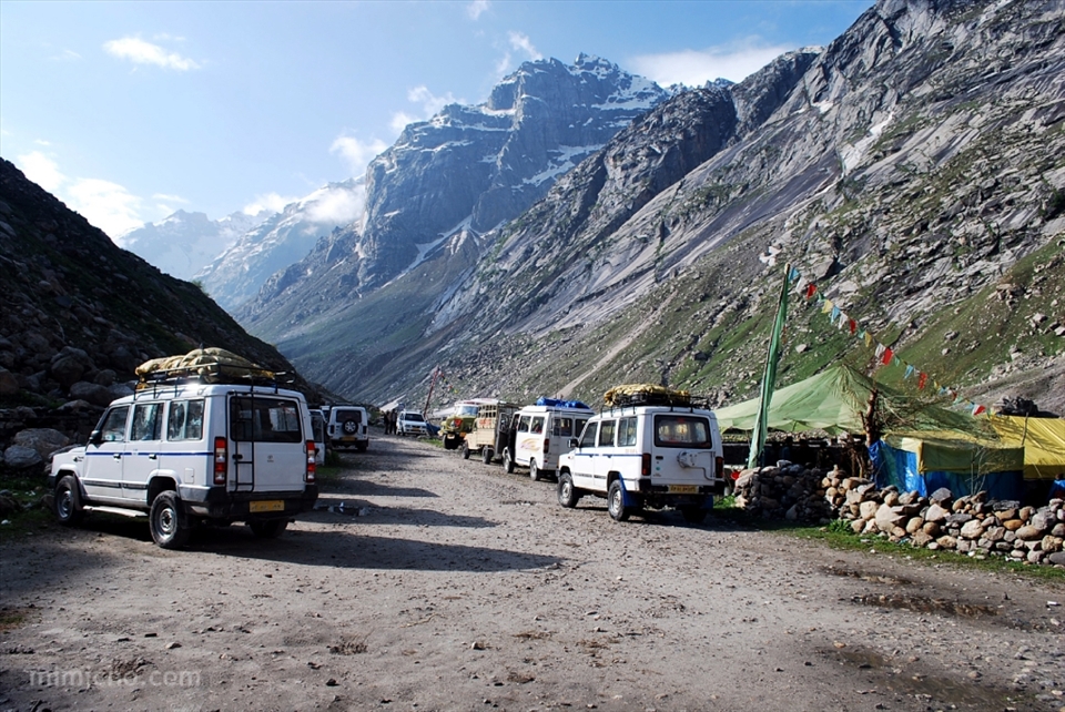 It's time to begin our descent. 60 hours from Himalayan isolation to one of the densest capital cities on earth begins on a minibus at 5000 metres above sea level. Our local escorts are so skilled at the wheel that the possibility of icy road blocks, flash floods and landslides hardly causes them to bat an eyelid.