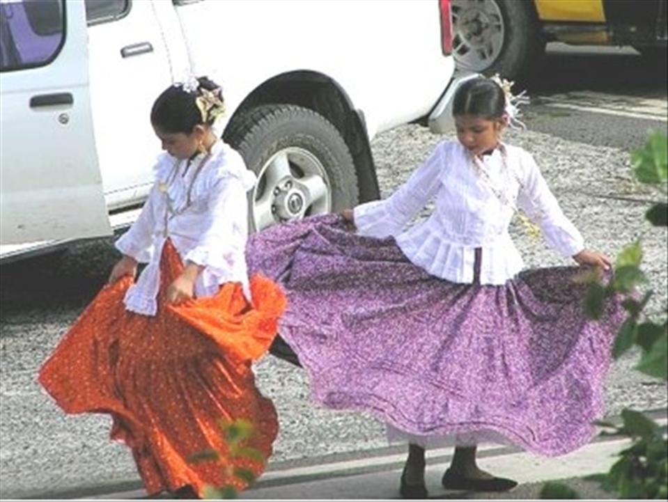 [TWIRLING PRACTICE]
Also at Catalina festival I witnessed this quiet moment between these two girls amidst the stimulus of the festival. They were in a car park practising twirling their skirts, for their participation in a parade. I later saw them and other females twirling in complicated ways, in rhythm to music. After observing them, I realised that twirling in a coordinated way was not an easy feat. The girls seemed to be taking their preparation very seriously and with much dedication. There also seemed to be extreme effort that had been paid to their appearance; they were wearing makeup and complex and ornate hair pieces (as we're other girls and women at the festival). This festival and participation in it seemed very important to local people in the town and a lot of energy had gone into it.