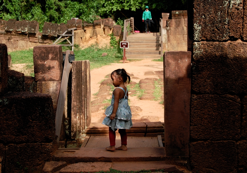 Barefooted this little Cambodian girl touches the red stones of Banteay Srei. She decided to follow me. 