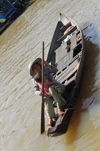 A mother with strong emotions and her child asking tourists for money. 