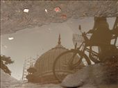 Monsoon moods - The reflection of the Jama Masjid tomb, along with that of a rickshaw puller, is visible in a shallow pit in an Old Delhi street. Monsoon in India is a time of extremes, joys and hardships both. While the nice weather gives much needed respite from the long hard summer, rains spells doom for people whose life is dependent on the crowd on streets. The tomb is under repair while the rickshaw puller has to wait for passengers, who are in scarcity at this time of year.: by mirror, Views[1453]