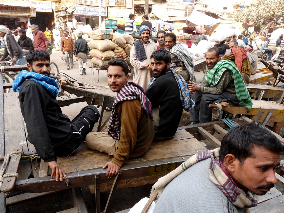 Smiles and hope - A group of Kashmiri migrant workers smiles at the camera. The ongoing militancy and daily clashes in Kashmir have made lives of local people very tough and cut the employment to nil. So, Kashmiris now have to migrate to other parts of India in search of odd jobs. Some bring with them woollen items and dry fruits and sell them in small towns and others, who don't have anything to offer, just resort to plain hard labour. With the hope that one day their homeland shall be peaceful and they shall return...
