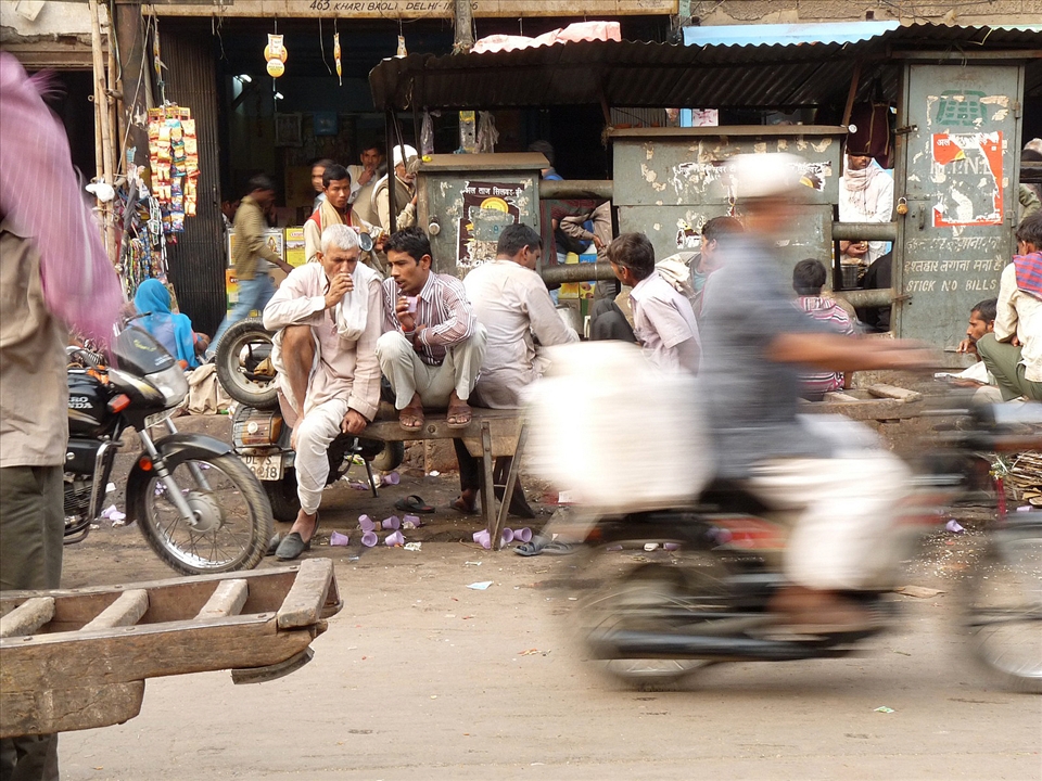 The tea break - Two friends have a tea break while the life goes on around them. Tea, introduced during the British rule, is the most popular drink all over India and tea breaks are a time to relax and socialise. A tea break can involve discussions of all type- business ideas, current affairs and politics, social issues, the day's news, sports, movies - basically anything and everything under the sun.