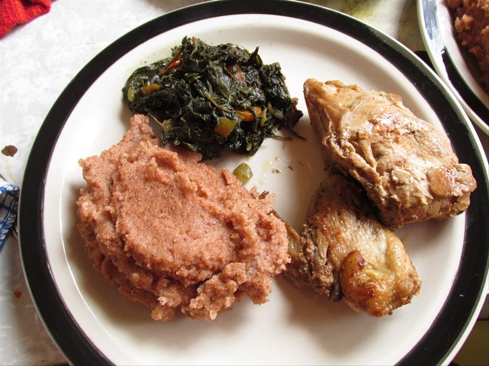 Sorghum meal with bean leaf stew and fried chicken