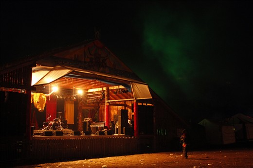 A single women crosses the deserted field after the show under a lingering cloud.