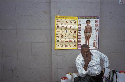Vendors own the sidewalks more than anyone. He points to my photo-eye.