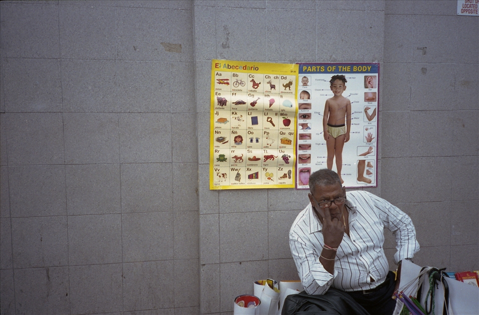 Vendors own the sidewalks more than anyone. He points to my photo-eye.