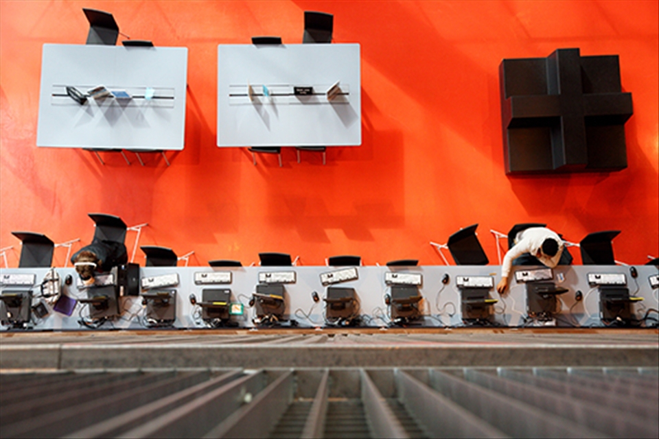 There are two people using the computer on the first floor of the library. (Seattle Public Library)