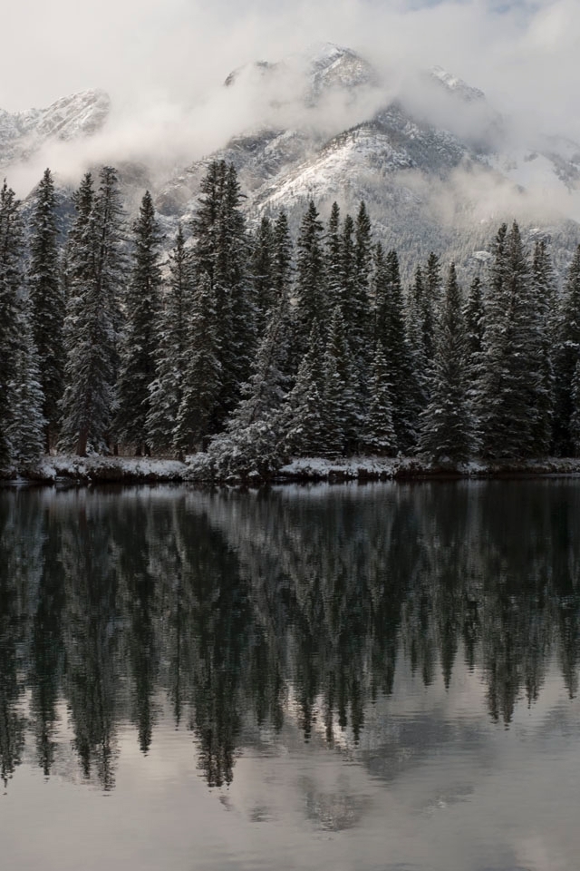 On a beautiful fall afternoon, the Bow River quietly flows, waiting in anticipation of the coming days when it will be a frozen slab of ice.  Soon, it will be thick enough to be walked upon by those wishing for easier access to the other side, and that which lies beyond. 

Bow River, Banff, Alberta, Canada
